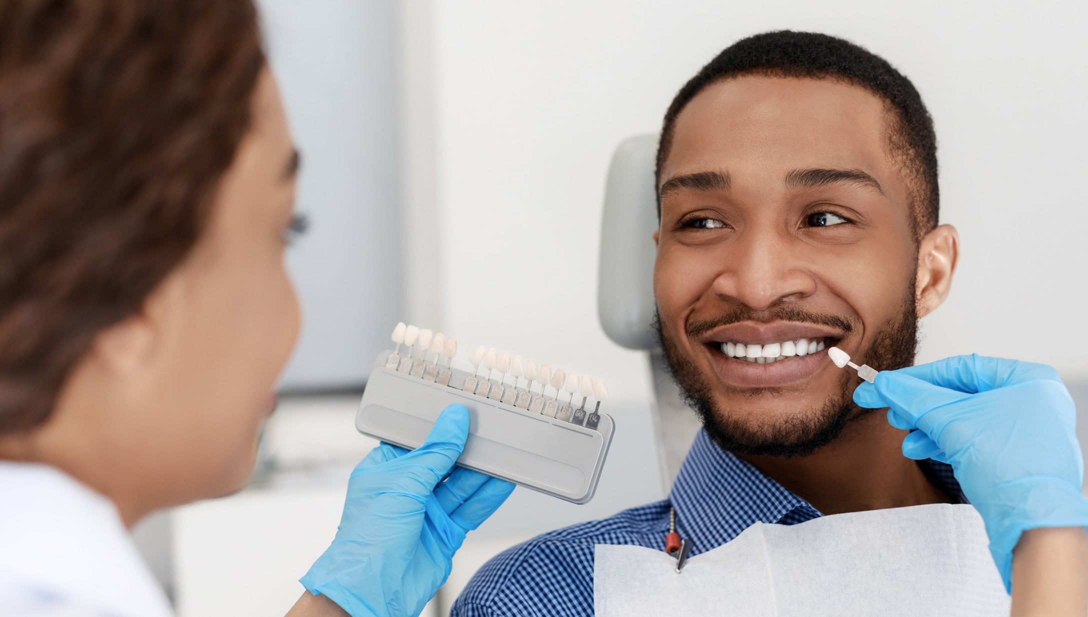 Smiling Young Man with Dental Assistant